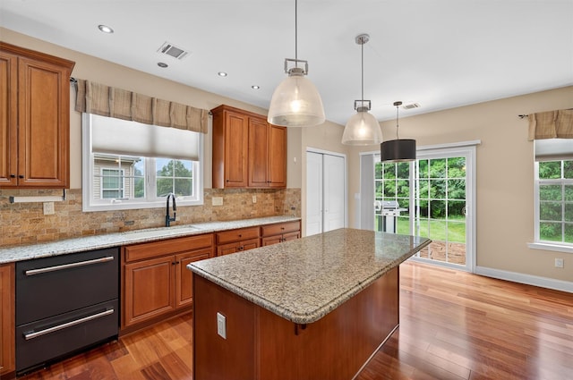 84 Jasmine Dr, Middletown, NY 10940 - kitchen featuring brown cabinetry, wood finished floors, backsplash, and recessed lighting