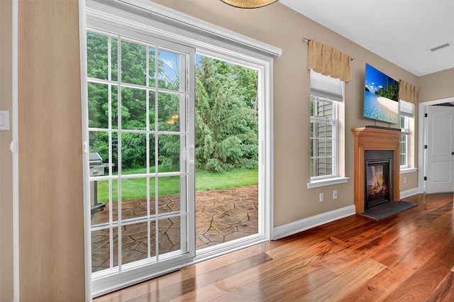 84 Jasmine Dr, Middletown, NY 10940 - doorway featuring wood finished floors, healthy amount of natural light, and a glass covered fireplace