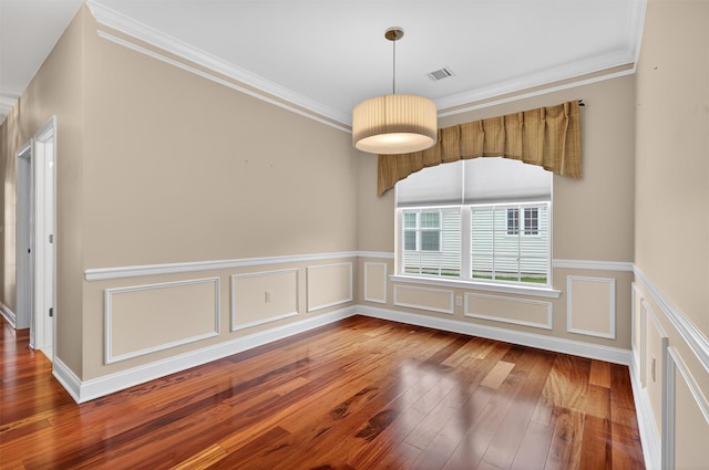84 Jasmine Dr, Middletown, NY 10940 - unfurnished dining area with hardwood / wood-style floors, crown molding, a wainscoted wall, and a decorative wall