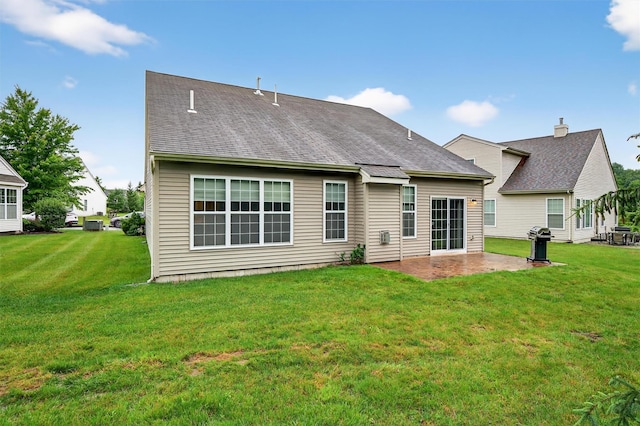 84 Jasmine Dr, Middletown, NY 10940 - rear view of house featuring a patio, a lawn, and roof with shingles