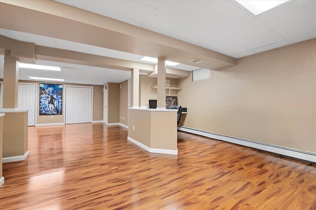 6 Laurelwood Ct, Dix Hills, NY 11746 - kitchen featuring baseboard heating, light wood-style flooring, open floor plan, and light countertops