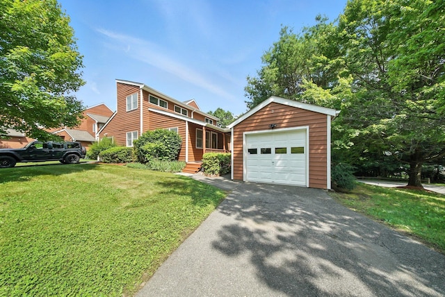 2 Woodland Way N, Ellenville, NY 12428 - view of front of property with a garage, an outdoor structure, a front lawn, and asphalt driveway