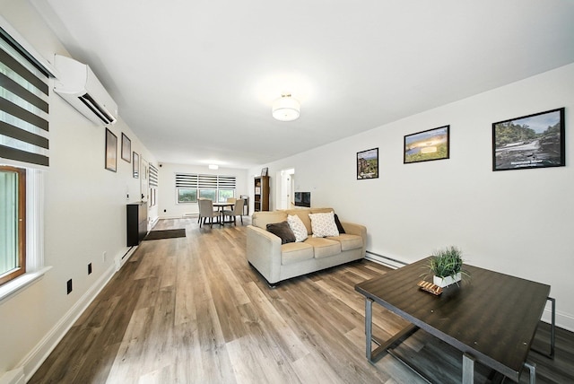 2 Woodland Way N, Ellenville, NY 12428 - living room featuring a wall unit AC, baseboard heating, and wood finished floors