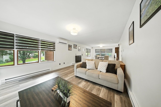 2 Woodland Way N, Ellenville, NY 12428 - living area featuring a baseboard heating unit, a wall mounted AC, wood finished floors, and a baseboard radiator