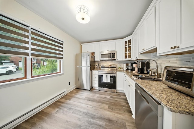 2 Woodland Way N, Ellenville, NY 12428 - kitchen with appliances with stainless steel finishes, baseboard heating, tasteful backsplash, and light wood-type flooring