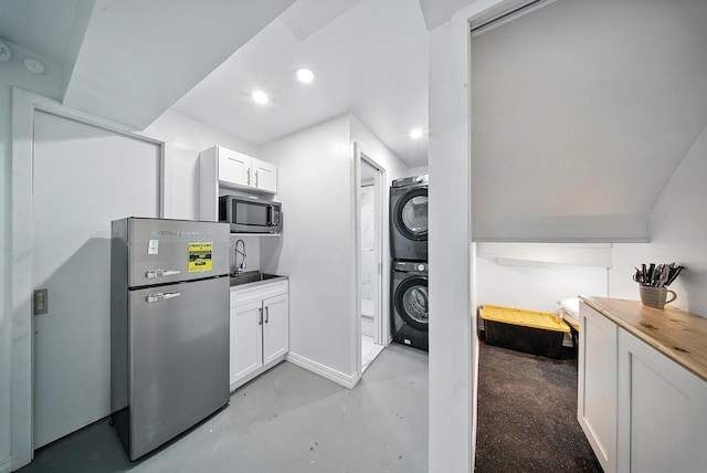 2 Woodland Way N, Ellenville, NY 12428 - kitchen featuring stainless steel appliances, stacked washing machine and dryer, finished concrete floors, white cabinetry, and recessed lighting