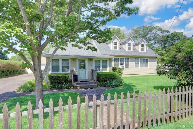 178 Magnolia Dr, Mastic Beach, NY 11951 - new england style home featuring a fenced front yard and a shingled roof