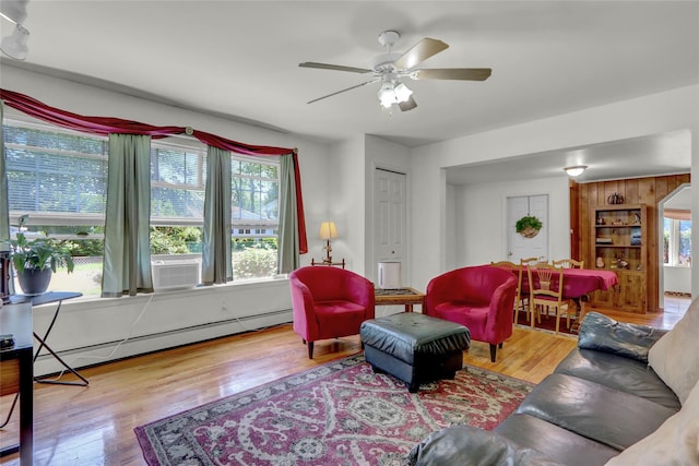 178 Magnolia Dr, Mastic Beach, NY 11951 - living area with a baseboard heating unit, healthy amount of natural light, wood finished floors, and a ceiling fan