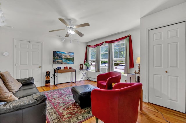 178 Magnolia Dr, Mastic Beach, NY 11951 - living room with a ceiling fan, a baseboard radiator, track lighting, and light wood-style flooring