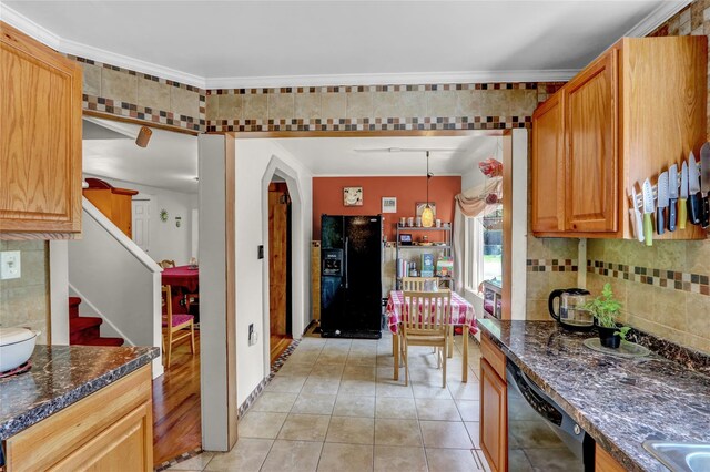 178 Magnolia Dr, Mastic Beach, NY 11951 - kitchen featuring black appliances, light tile patterned floors, backsplash, dark stone counters, and arched walkways
