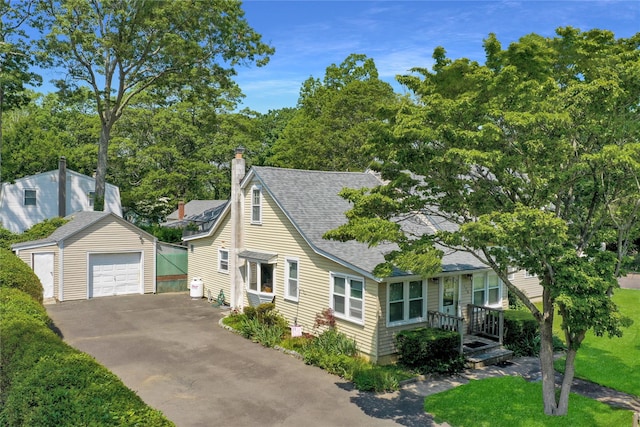 178 Magnolia Dr, Mastic Beach, NY 11951 - view of front of house with an outbuilding, roof with shingles, a garage, driveway, and a chimney