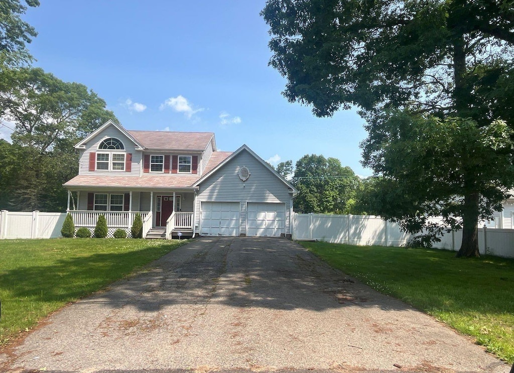 85 Patchogue Ave, Mastic, NY 11950 - colonial house featuring a porch, a garage, and asphalt driveway