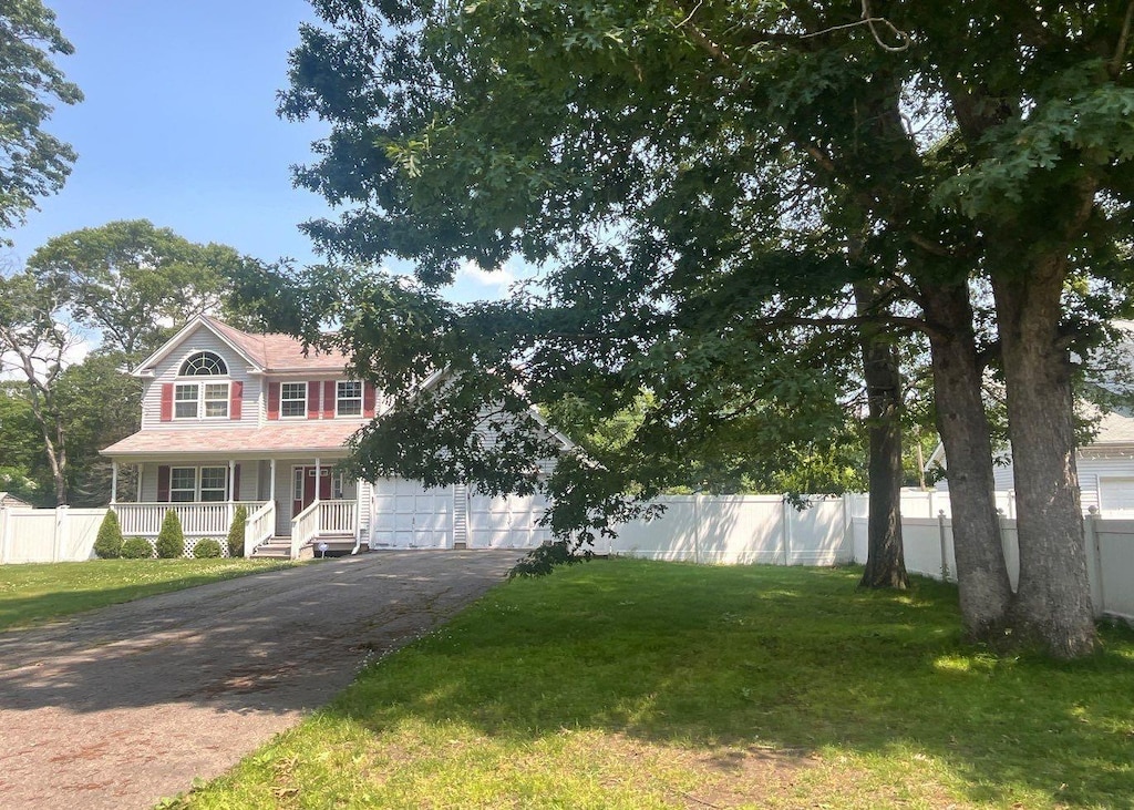 85 Patchogue Ave, Mastic, NY 11950 - view of front facade with a porch, driveway, and a garage