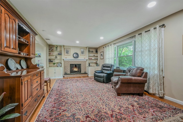 18 Huyler Ct, Setauket, NY 11733 - living area featuring light wood-style floors, recessed lighting, and a brick fireplace