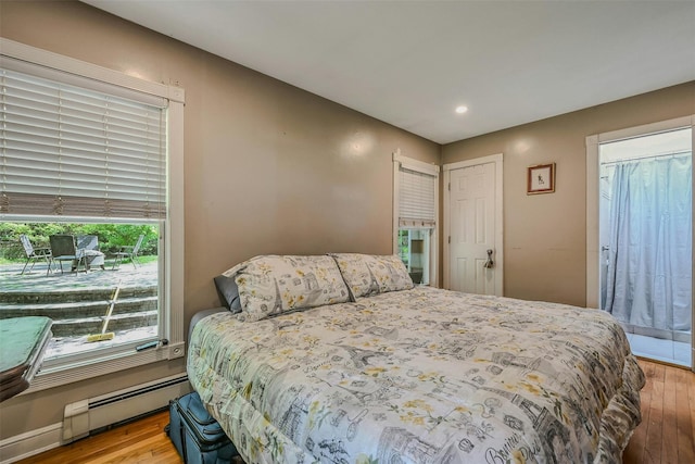 18 Huyler Ct, Setauket, NY 11733 - bedroom featuring baseboard heating, wood finished floors, and recessed lighting