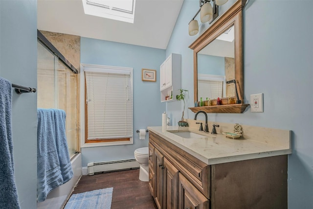 18 Huyler Ct, Setauket, NY 11733 - bathroom with baseboard heating, vanity, a skylight, wood finished floors, and bath / shower combo with glass door