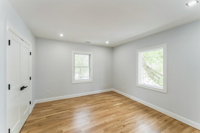 237 Linden Ave, Westbury, NY 11590 - unfurnished bedroom with multiple windows, light wood-type flooring, and recessed lighting