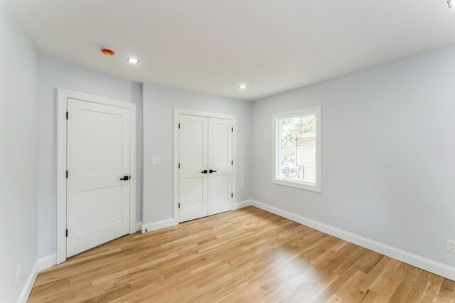 237 Linden Ave, Westbury, NY 11590 - unfurnished bedroom featuring light wood-style flooring, recessed lighting, and a closet