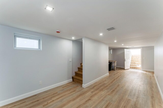 237 Linden Ave, Westbury, NY 11590 - basement featuring stairway, light wood-style floors, recessed lighting, healthy amount of natural light, and a fireplace