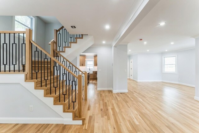 237 Linden Ave, Westbury, NY 11590 - stairs with ornamental molding, wood finished floors, and recessed lighting