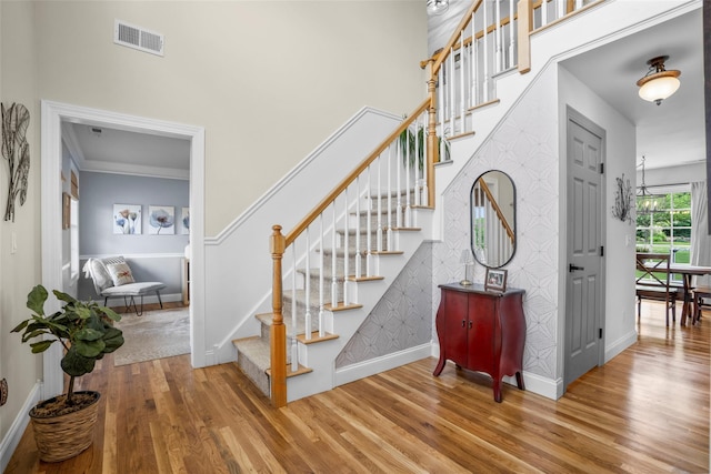 38 Southview Ct, Poughkeepsie, NY 12603 - staircase with wood finished floors, wallpapered walls, an accent wall, and a high ceiling