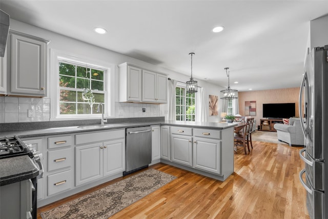 38 Southview Ct, Poughkeepsie, NY 12603 - kitchen with stainless steel appliances, open floor plan, dark countertops, a peninsula, and recessed lighting