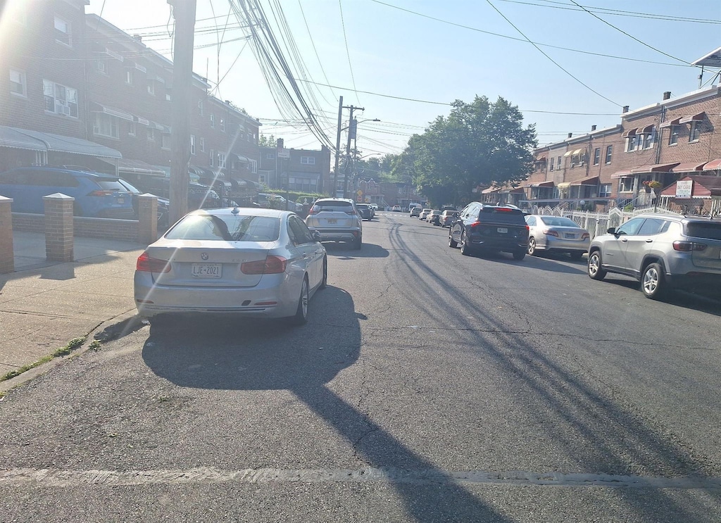 1037 E 219th St, Bronx, NY 10469 - view of asphalt street with street lighting, curbs, and sidewalks