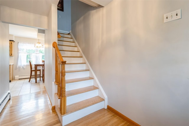 51 Lester Dr, Orangeburg, NY 10962 - stairs featuring wood finished floors, a baseboard radiator, and a chandelier