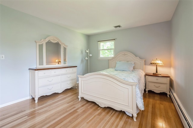 51 Lester Dr, Orangeburg, NY 10962 - bedroom with a baseboard radiator and light wood-style flooring
