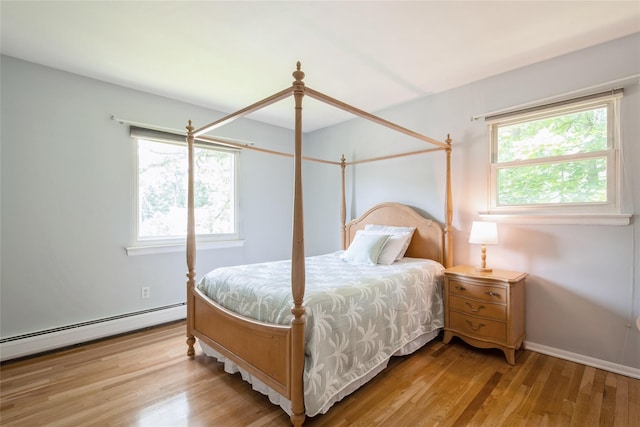 51 Lester Dr, Orangeburg, NY 10962 - bedroom with multiple windows, wood finished floors, and baseboard heating