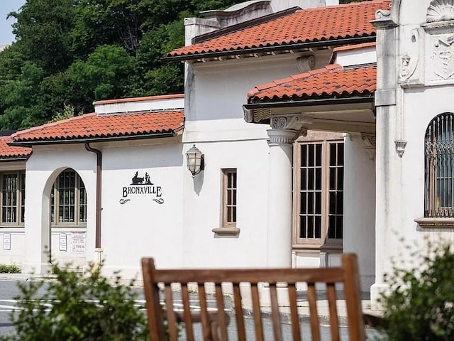 72 Pondfield Rd W Unit 2F, Bronxville, NY 10708 - view of side of property with a tiled roof and stucco siding