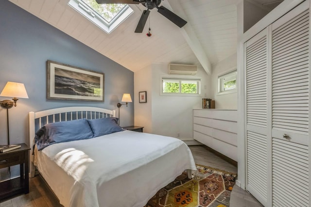 35 Library Ave Unit 8X, Westhampton Beach, NY 11978 - bedroom with a wall mounted air conditioner, dark wood-style flooring, a closet, a skylight, and a ceiling fan