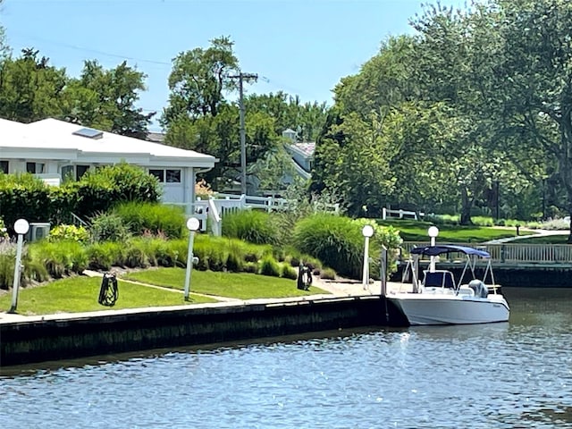 35 Library Ave Unit 8X, Westhampton Beach, NY 11978 - dock area with a water view, a yard, and view of wooded area