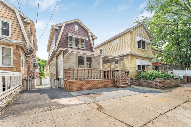 4216 Wickham Ave, Bronx, NY 10466 - colonial inspired home featuring a porch, a gambrel roof, and a gate