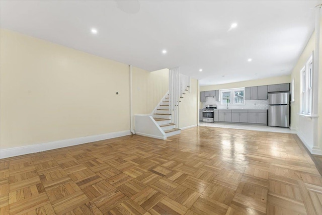 4216 Wickham Ave, Bronx, NY 10466 - unfurnished living room featuring stairs and recessed lighting