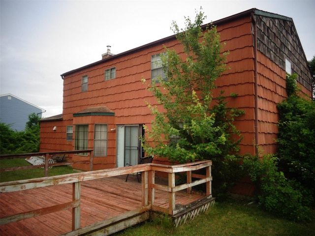 113 Camille Ln, East Patchogue, NY 11772 - rear view of house with a wooden deck, a chimney, and a lawn