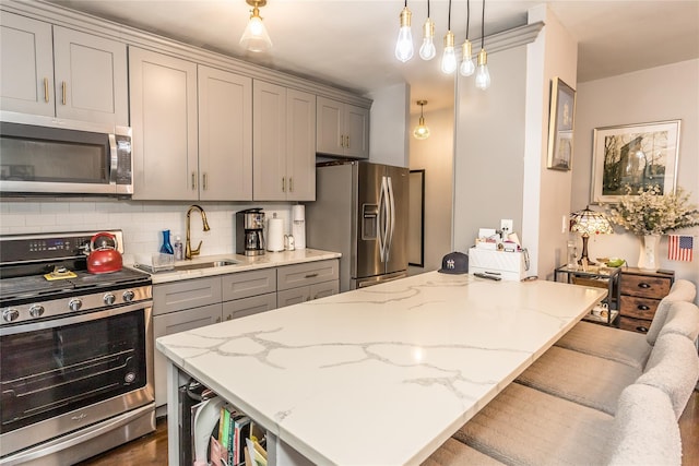 30-47 Hobart St Unit 6, Woodside, NY 11377 - kitchen with stainless steel appliances, gray cabinetry, light stone counters, backsplash, and hanging light fixtures