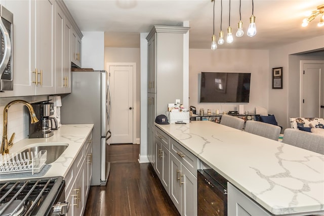 30-47 Hobart St Unit 6, Woodside, NY 11377 - kitchen with gray cabinetry, open floor plan, dark wood-type flooring, appliances with stainless steel finishes, and beverage cooler