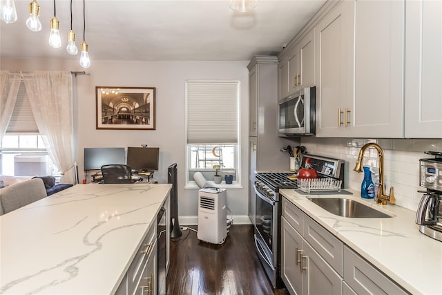 30-47 Hobart St Unit 6, Woodside, NY 11377 - kitchen with stainless steel appliances, dark wood-style flooring, backsplash, gray cabinets, and decorative light fixtures