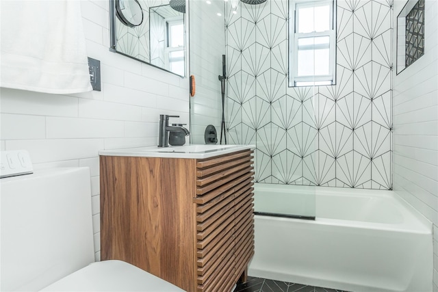 30-47 Hobart St Unit 6, Woodside, NY 11377 - bathroom with washer / clothes dryer, bathtub / shower combination, vanity, and tile walls