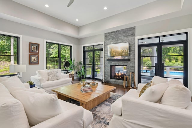 317 Old Mill Rd, Nissequogue, NY 11780 - living room with french doors, a stone fireplace, recessed lighting, wood finished floors, and a ceiling fan