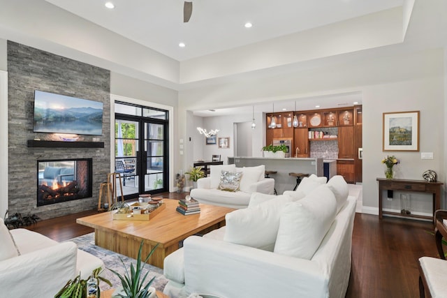 317 Old Mill Rd, Nissequogue, NY 11780 - living room featuring dark wood-style flooring, a fireplace, recessed lighting, a ceiling fan, and a high ceiling