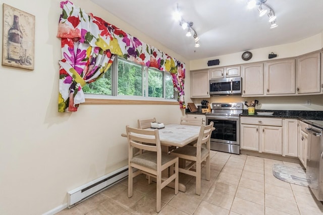 1106 Parkview Dr, Southfields, NY 10975 - kitchen featuring stainless steel appliances, a baseboard heating unit, light tile patterned flooring, and dark countertops