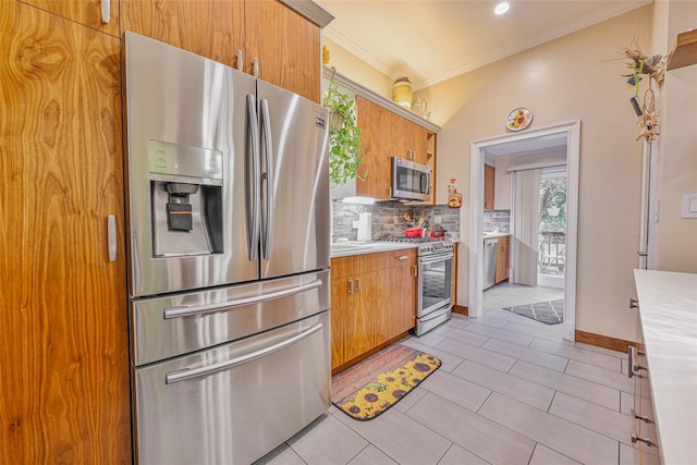 129 Guenther Ave, Valley Stream, NY 11580 - kitchen with stainless steel appliances, light countertops, backsplash, crown molding, and brown cabinets