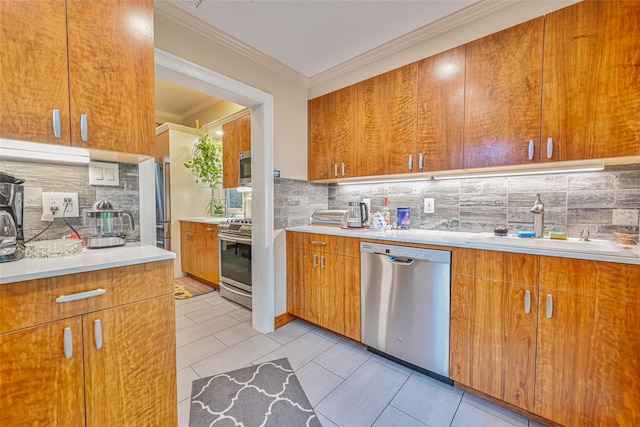 129 Guenther Ave, Valley Stream, NY 11580 - kitchen with appliances with stainless steel finishes, crown molding, tasteful backsplash, brown cabinetry, and light countertops