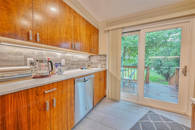 129 Guenther Ave, Valley Stream, NY 11580 - kitchen featuring dishwasher, crown molding, tasteful backsplash, light tile patterned floors, and light countertops