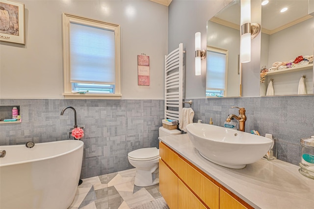 129 Guenther Ave, Valley Stream, NY 11580 - full bathroom with radiator, tile walls, a freestanding bath, a wainscoted wall, and vanity