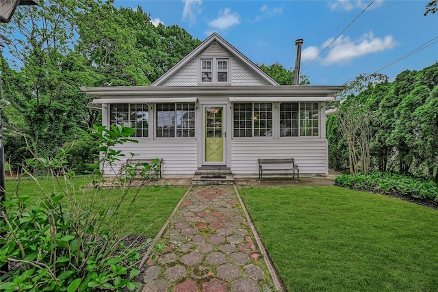 56 Locust Dr, Rocky Point, NY 11778 - bungalow-style home featuring entry steps and a front lawn