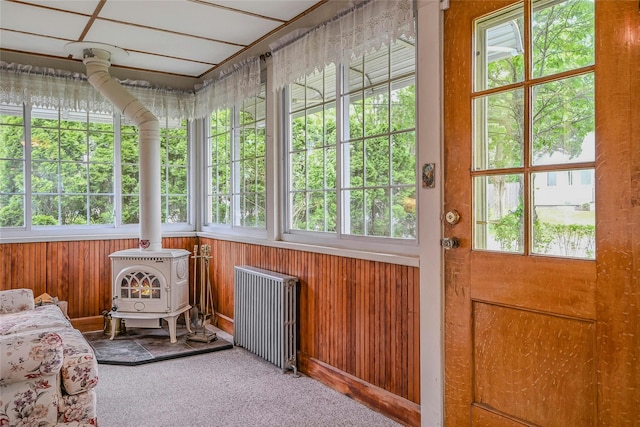 56 Locust Dr, Rocky Point, NY 11778 - sunroom / solarium with radiator heating unit and a wood stove