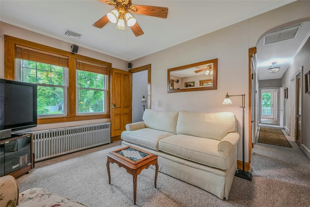 56 Locust Dr, Rocky Point, NY 11778 - carpeted living area featuring radiator heating unit, a ceiling fan, and plenty of natural light
